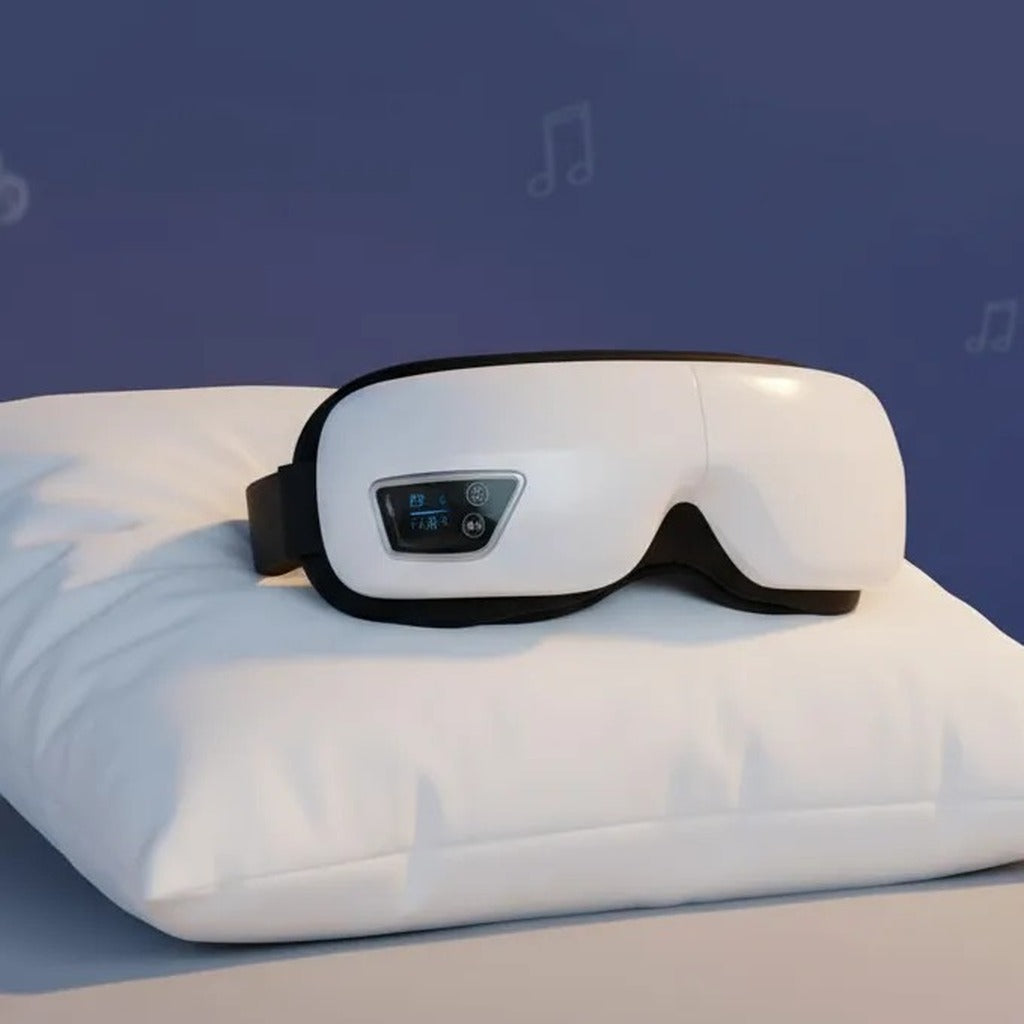 Masajeador de ojos sobre una almohada, panel de control y modo de música